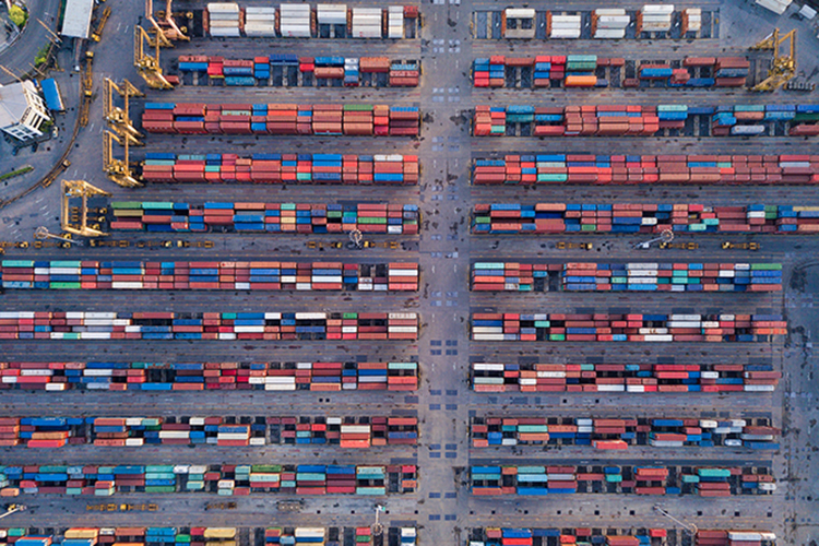 Aerial top view of container cargo ship in the export and import business and logistics international goods in urban city. Shipping cargo to the harbor by crane.